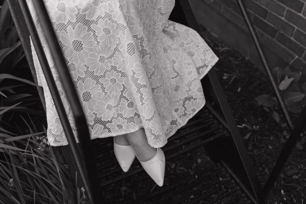 Felt Estate engagement photos detail shot of lace dress and heels on staircase black and white Michigan