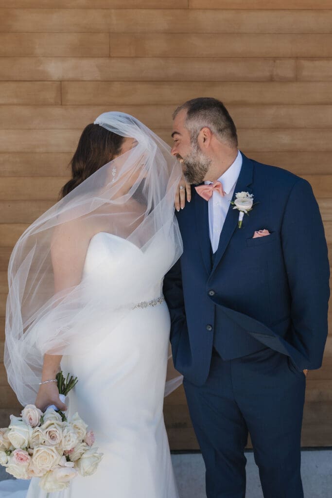 Bride and groom sharing a candid wedding portrait at Leona Road in Grand Rapids, Michigan