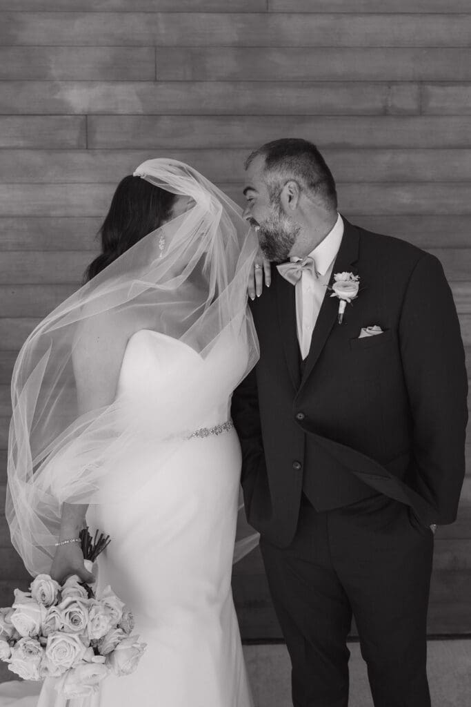 Bride and groom sharing a candid wedding portrait at Leona Road in Grand Rapids, Michigan